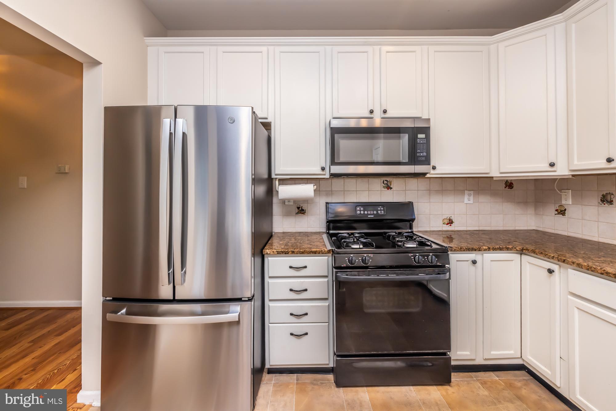 209 Kendig Road Coatesville, PA 19320 - Photo 5 of 47 a kitchen with refrigerator a stove and microwave