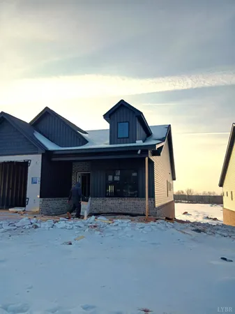 a view of a house with a garage and yard