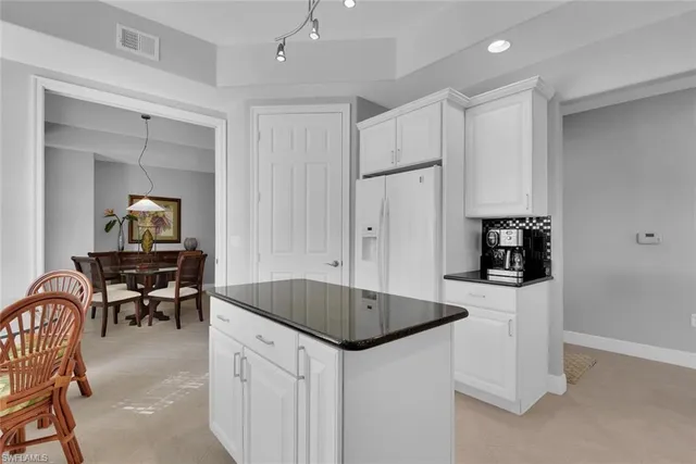 a kitchen that has a cabinets and a table in it