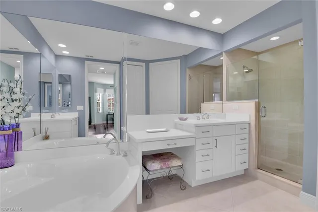 a bathroom with a double vanity sink mirror and shower