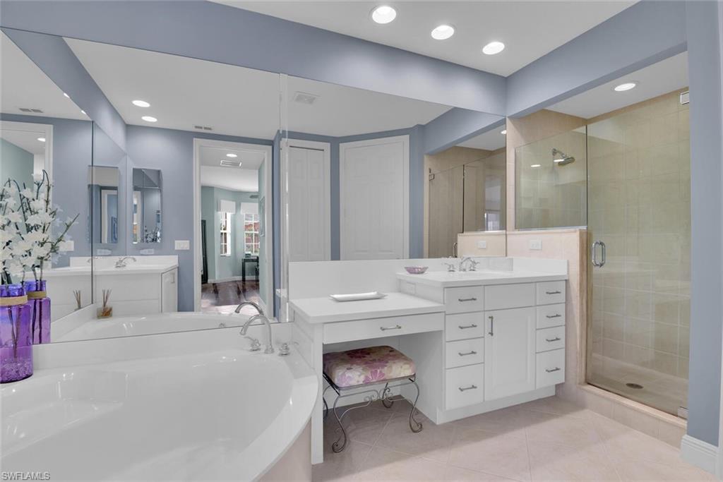 6413 Legacy Circle, Unit 1602 Naples, FL 34113 - Photo 23 of 34 a bathroom with a double vanity sink mirror and shower
