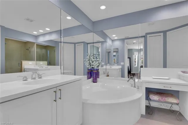 a bathroom with a sink double vanity and a mirror