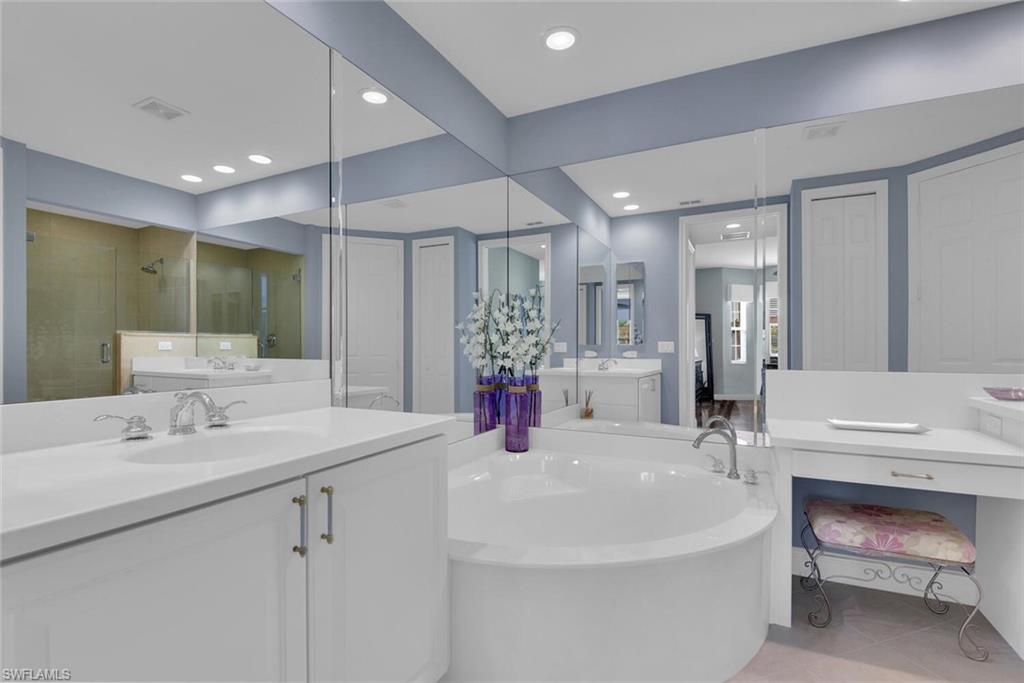 6413 Legacy Circle, Unit 1602 Naples, FL 34113 - Photo 24 of 34 a bathroom with a sink double vanity and a mirror