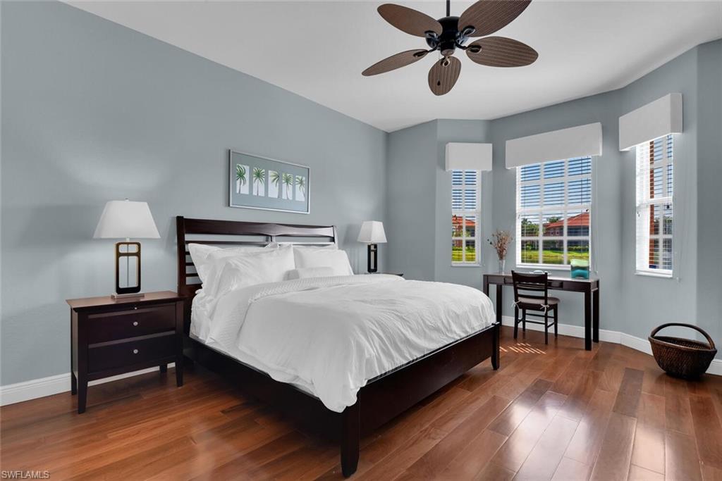 6413 Legacy Circle, Unit 1602 Naples, FL 34113 - Photo 25 of 34 a bedroom with a bed and wooden floor