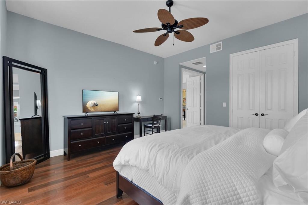 6413 Legacy Circle, Unit 1602 Naples, FL 34113 - Photo 26 of 34 a bedroom with a bed and a dresser