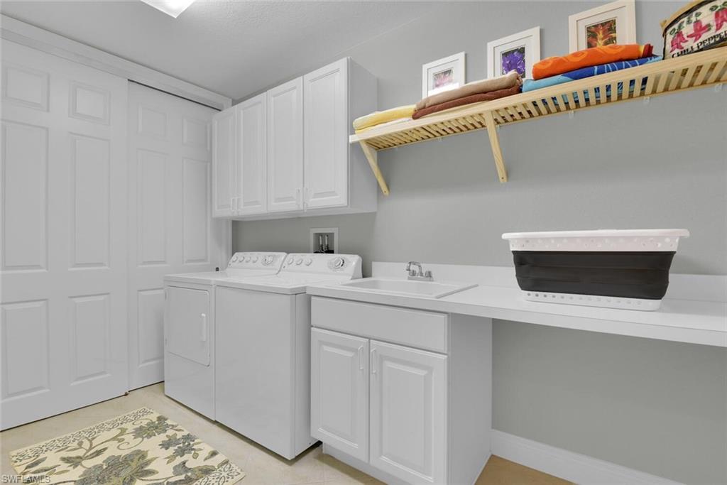 6413 Legacy Circle, Unit 1602 Naples, FL 34113 - Photo 28 of 34 a utility room with dryer and washer