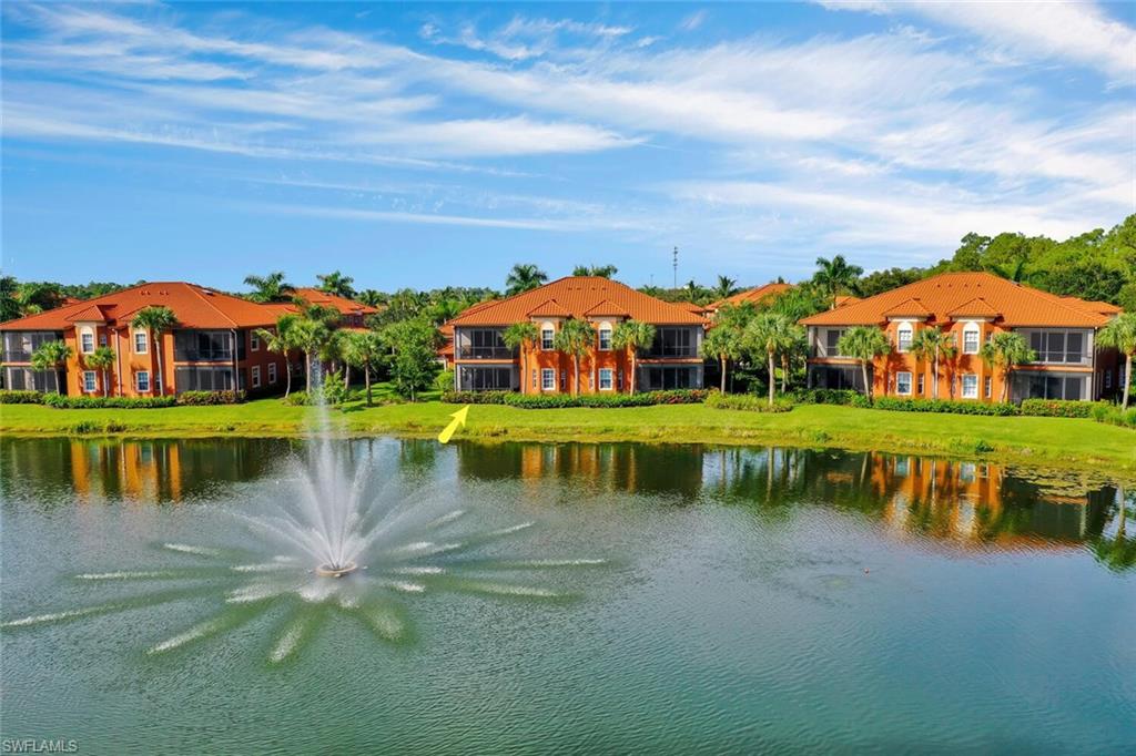 6413 Legacy Circle, Unit 1602 Naples, FL 34113 - Photo 32 of 34 a view of a lake with a building in the background