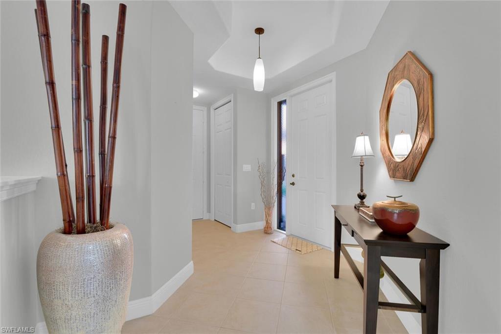 6413 Legacy Circle, Unit 1602 Naples, FL 34113 - Photo 5 of 34 a living room with furniture and a mirror