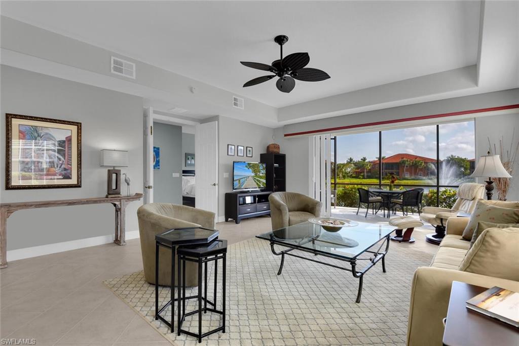 6413 Legacy Circle, Unit 1602 Naples, FL 34113 - Photo 8 of 34 a living room with furniture and a large window