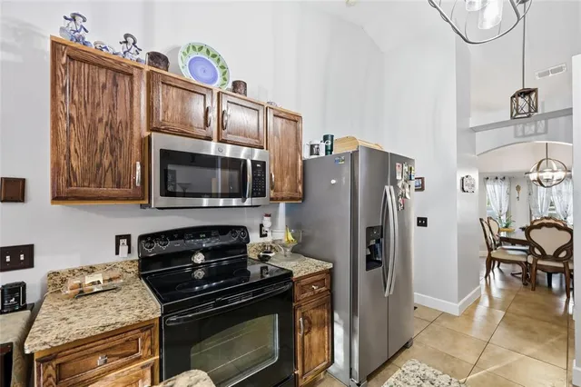 a kitchen with stainless steel appliances granite countertop a sink stove and cabinets