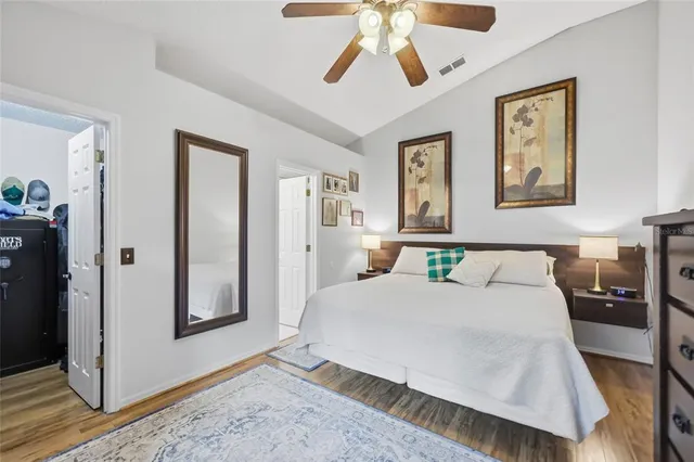 a bedroom with a bed and wooden floor