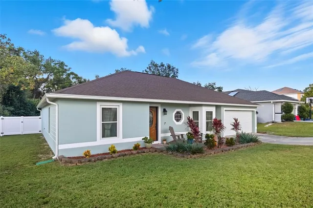a front view of house with yard and green space