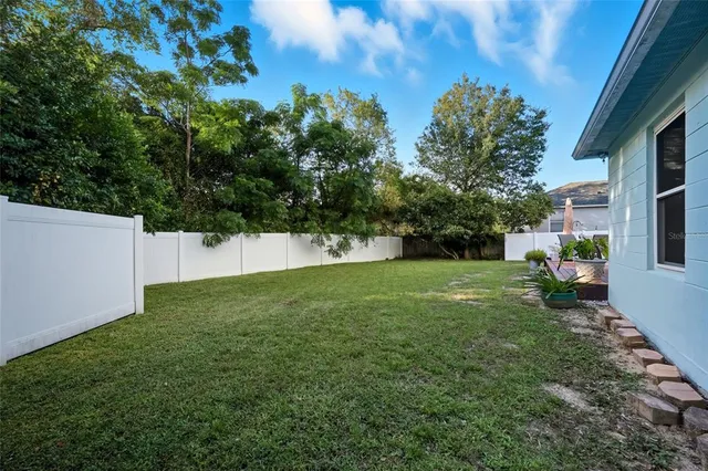 an aerial view of house with yard