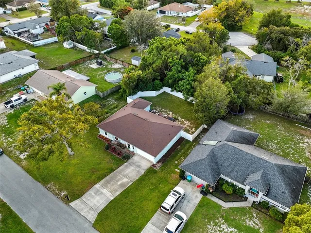 an aerial view of a house with yard and outdoor seating