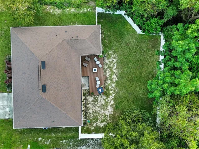 an aerial view of residential houses with outdoor space and street view
