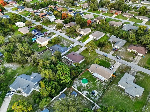 an aerial view of residential houses with outdoor space and street view