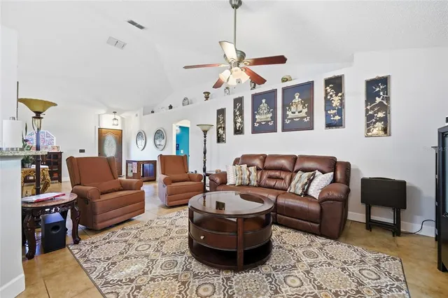a living room with furniture and a kitchen view