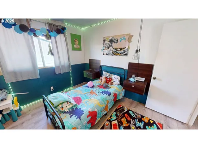 a bed room with a bed and a wall painting