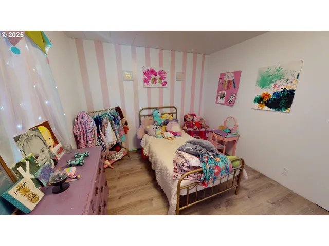 a bedroom with a bed a couch and a painting on the wall