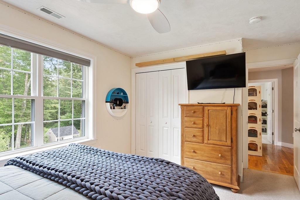 46 Jordan Road Holden, MA 01520 - Photo 23 of 42 a bedroom with a bed and flat screen tv