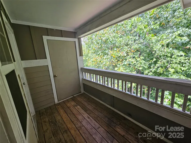 a view of a balcony with wooden floor