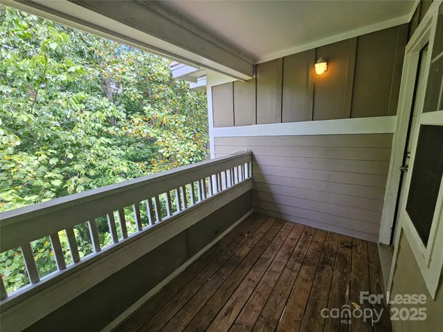 a view of a balcony with wooden floor