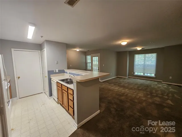 a kitchen with a stove and a refrigerator