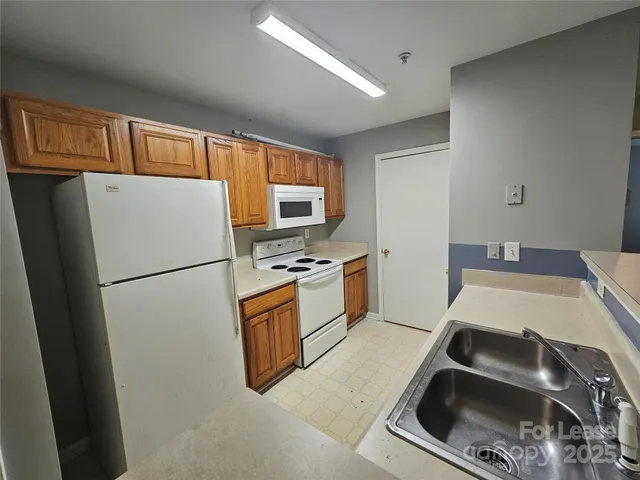 a kitchen with stainless steel appliances a refrigerator stove and microwave