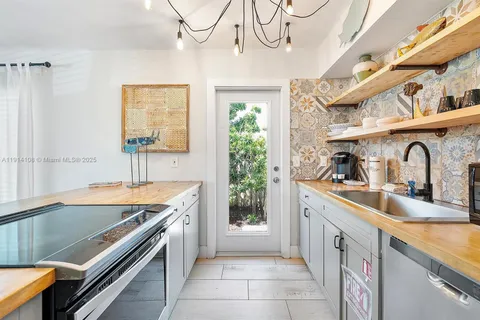 a kitchen with stainless steel appliances granite countertop a sink and a stove