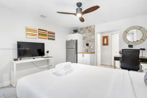 a bedroom with a bed and a flat screen tv