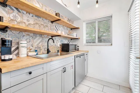 a kitchen with a sink cabinets and a window