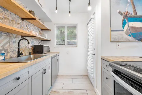 a kitchen with a sink stove and cabinets