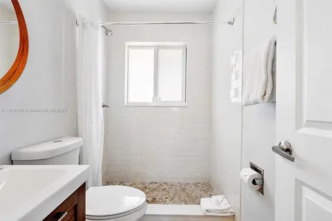 a white toilet sitting next to a bathroom sink