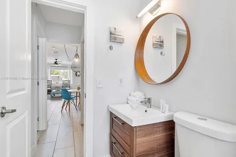 a bathroom with a sink a mirror and a toilet