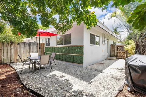 an outdoor space with furniture and umbrella