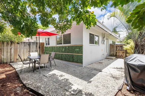an outdoor space with furniture and umbrella