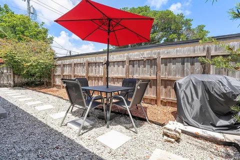 a view of a house with backyard sitting area and garden