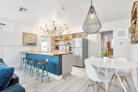 a kitchen with a dining table and chairs