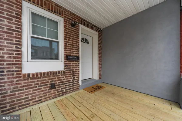 a view of a big room with wooden floor and windows