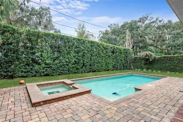 a view of a pool with a yard