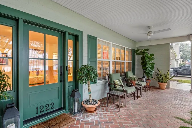 a living room with furniture and a potted plant