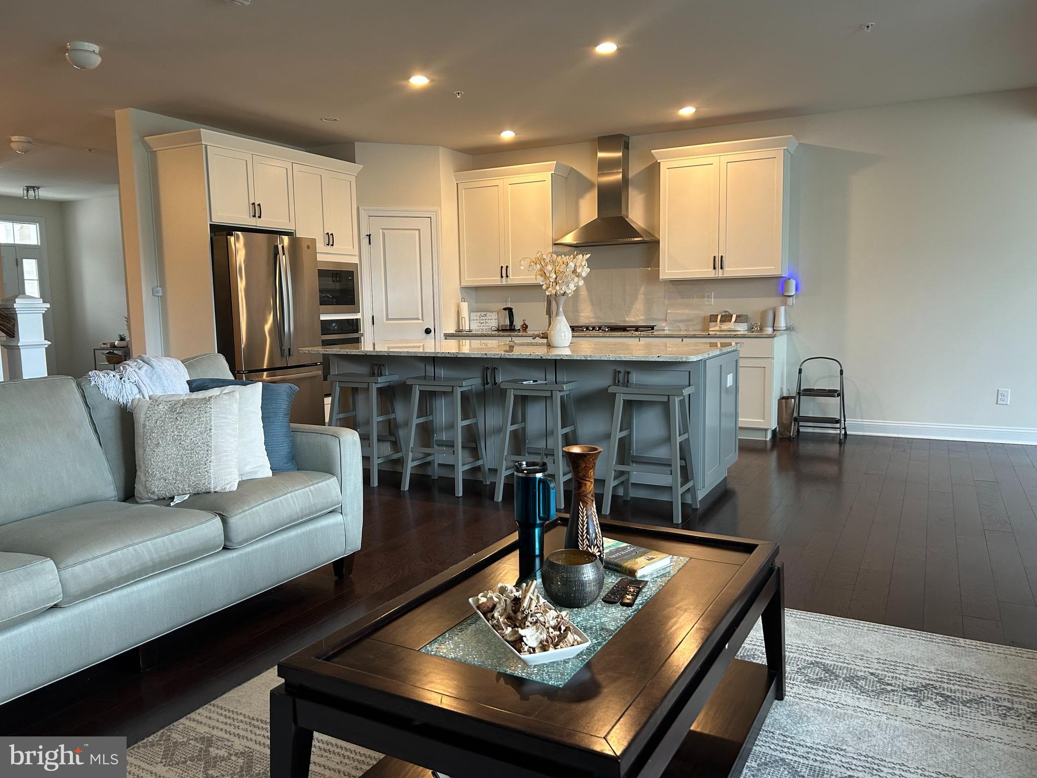 21 Midsummer Drive Newtown Square, PA 19073 - Photo 4 of 11 a living room with stainless steel appliances furniture a dining table and kitchen view