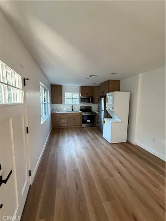 a view of kitchen with furniture and wooden floor