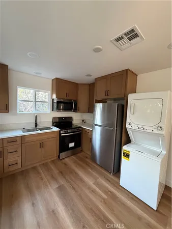 a kitchen with sink cabinets and stainless steel appliances