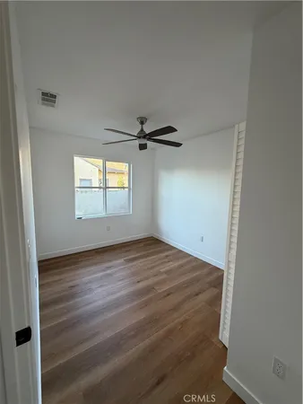 an empty room with windows and closet
