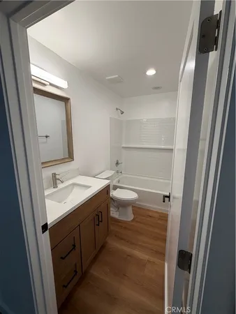 a bathroom with a double vanity sink toilet and mirror