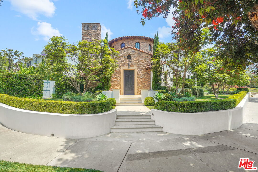 700 Alma Real Drive Pacific Palisades, CA 90272 - Photo 1 of 32 a view of a white house with a fountain and a potted plant