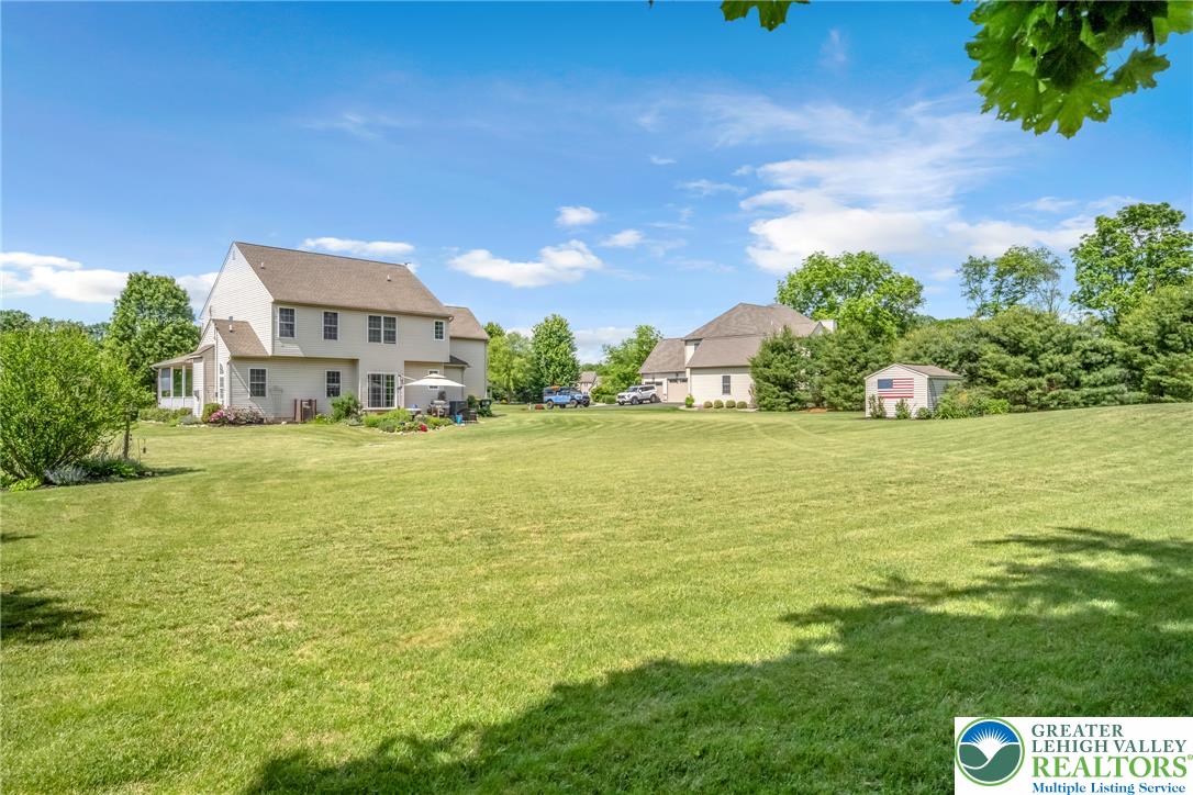 204 Bushkill Ridge Road Wind Gap, PA 18091 - Photo 6 of 48 A spacious backyard provides ample green space and a quaint storage shed.