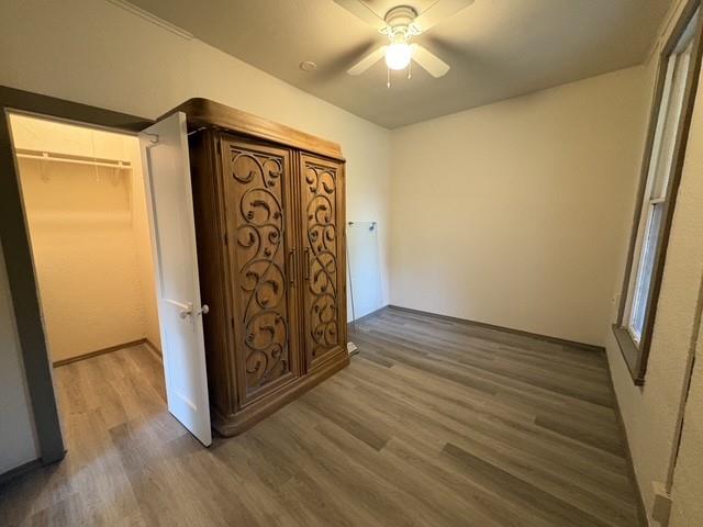4876 East Williams Spring Road Fort Worth, TX 76135 - Photo 17 of 20 an empty room with wooden floor and fan
