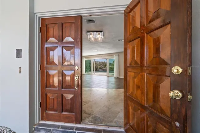 a view of a room with wooden floor and a floor to ceiling window